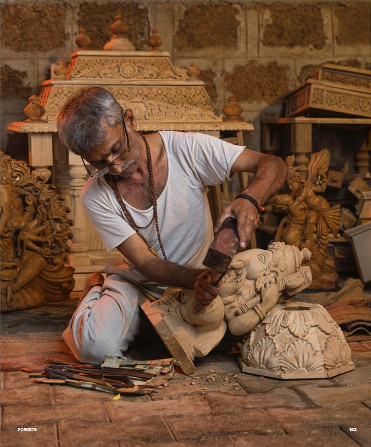 Artisan carving a wooden sculpture
